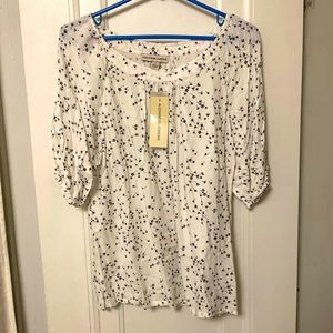 White flowy short-sleeve blouse with black feather print